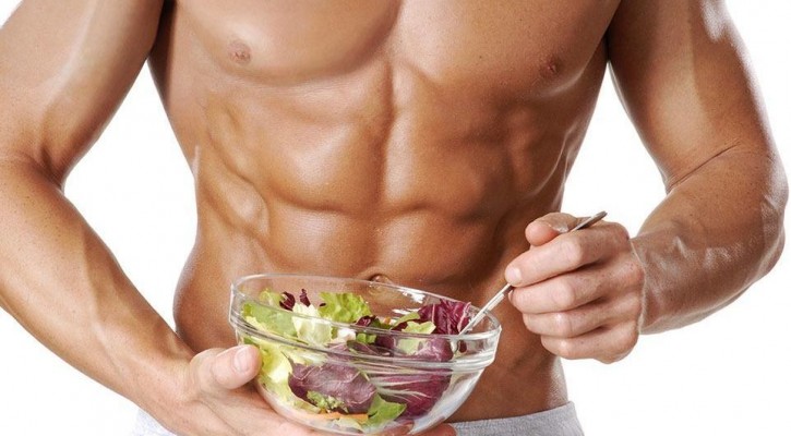 muscular man eating salad