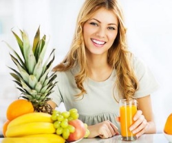 woman holding glass of juice