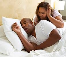 man snoring and woman covering ears